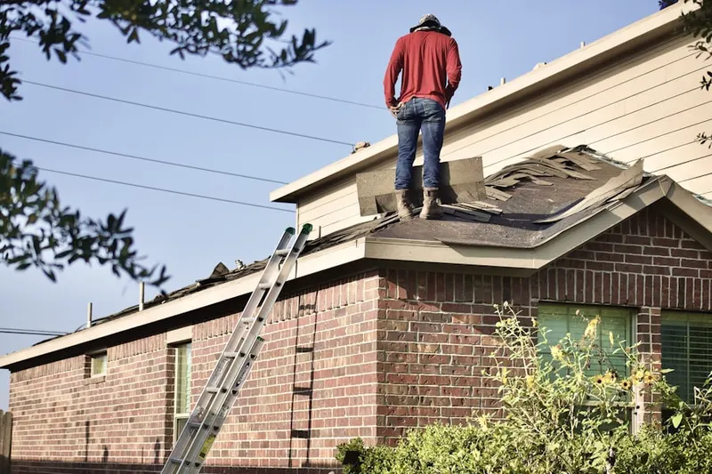 Professional roofer working on a residential roof in Woodcreek